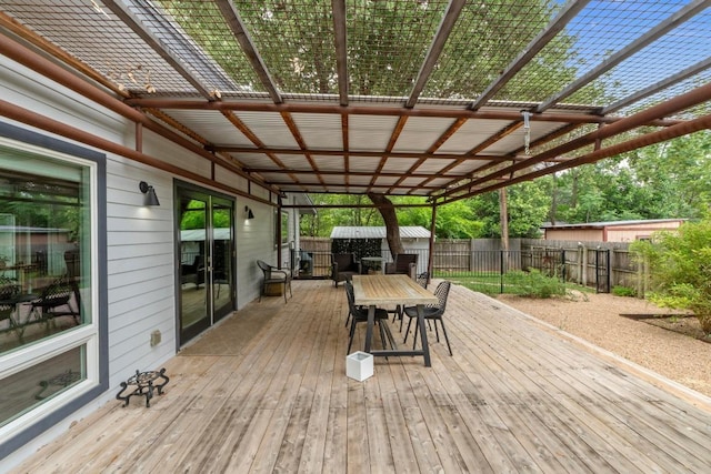 1705 Westmoor Dr, Austin, TX 78723 - wooden deck featuring outdoor dining space, a fenced backyard, and a storage unit