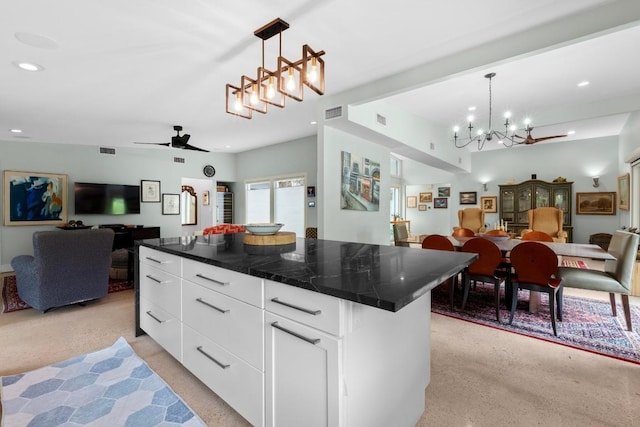 1705 Westmoor Dr, Austin, TX 78723 - kitchen with open floor plan, recessed lighting, a chandelier, dark countertops, and white cabinets