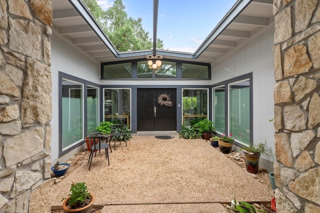 1705 Westmoor Dr, Austin, TX 78723 - property entrance featuring stone siding and a patio area