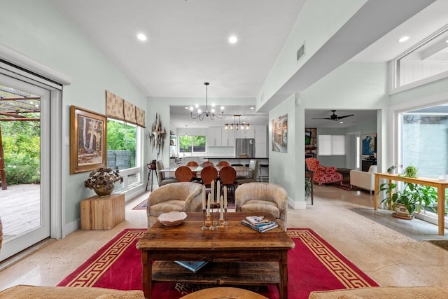 living room with recessed lighting, visible vents, plenty of natural light, and ceiling fan with notable chandelier
