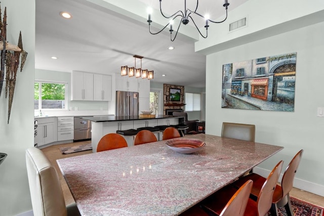 dining area with baseboards, visible vents, recessed lighting, and a notable chandelier