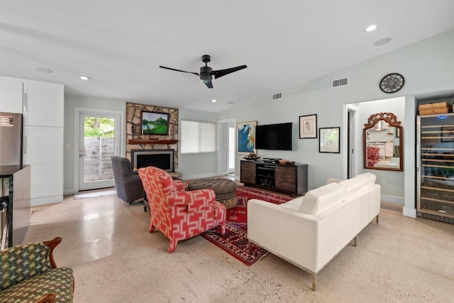 living room featuring ceiling fan, visible vents, a fireplace, wine cooler, and recessed lighting