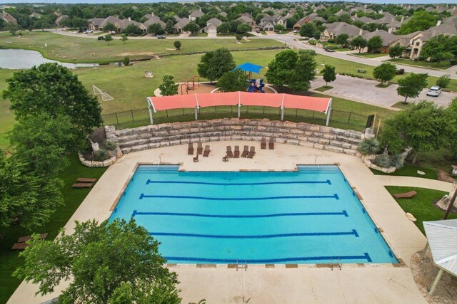 view of swimming pool featuring fence and a residential view