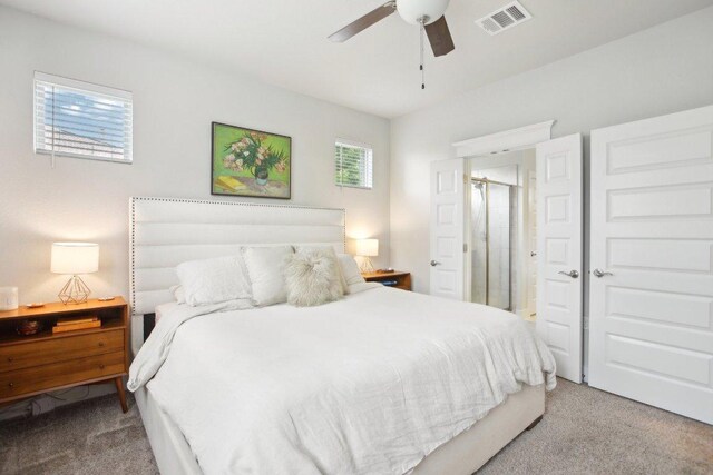carpeted bedroom featuring visible vents and a ceiling fan