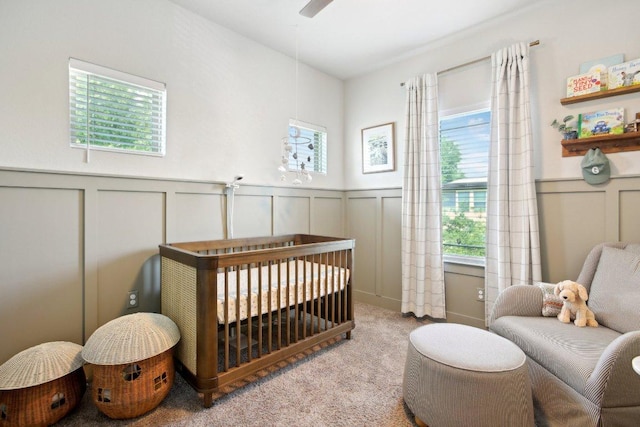 1708 Loyal Friend Dr Unit 46, Leander, TX 78641 - carpeted bedroom featuring a decorative wall, a crib, and wainscoting