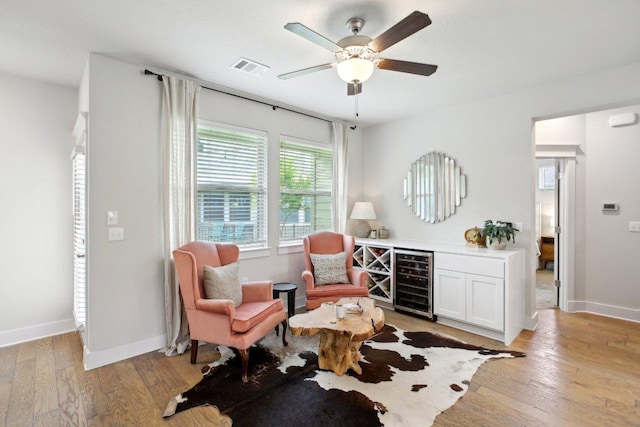 1708 Loyal Friend Dr Unit 46, Leander, TX 78641 - living area featuring beverage cooler, light wood-style flooring, a ceiling fan, baseboards, and a dry bar