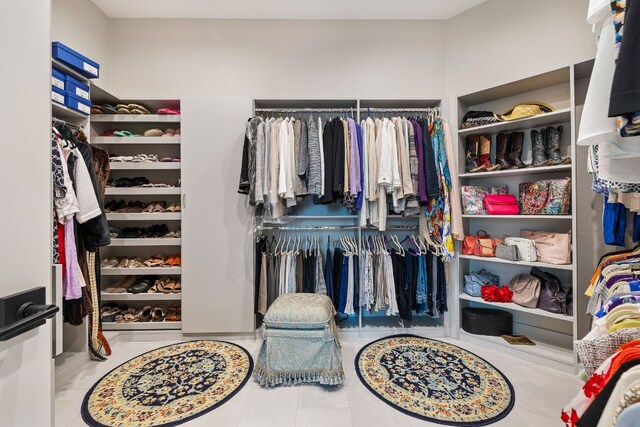 walk in closet with tile patterned flooring
