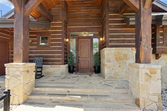 property entrance featuring stone siding