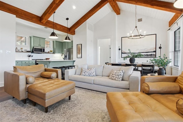 18852 Hidden Ridge Pl, Jonestown, TX 78645 - living area with visible vents, beam ceiling, high vaulted ceiling, a notable chandelier, and light wood-style flooring