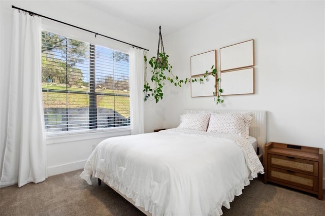 bedroom featuring baseboards and carpet