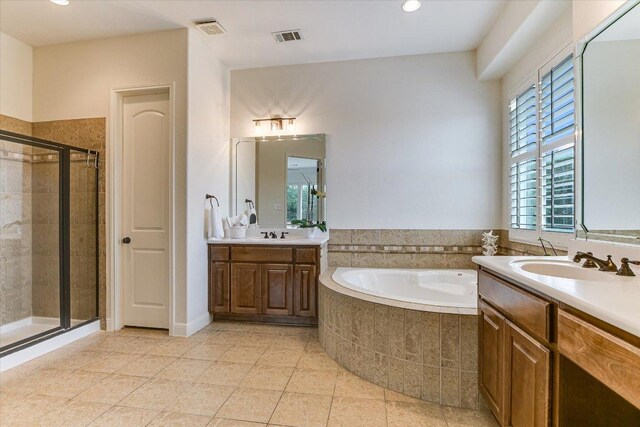 full bathroom with tile patterned flooring, a stall shower, a garden tub, and visible vents
