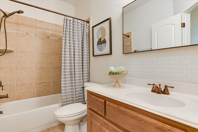 bathroom featuring toilet, shower / bath combination with curtain, and vanity