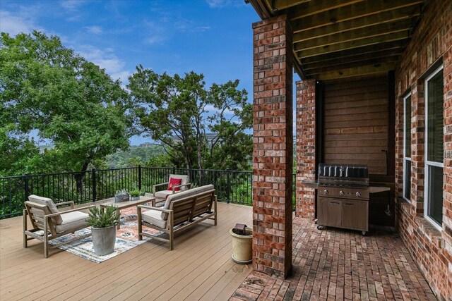 deck with outdoor lounge area and a grill