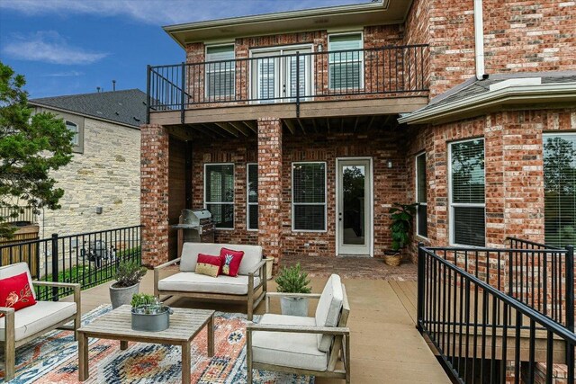 view of patio / terrace featuring area for grilling, outdoor lounge area, and a balcony