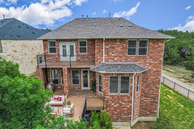 back of property featuring roof with shingles, a yard, an outdoor living space, and a balcony