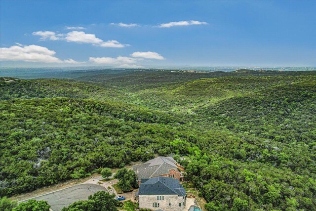 birds eye view of property featuring a view of trees