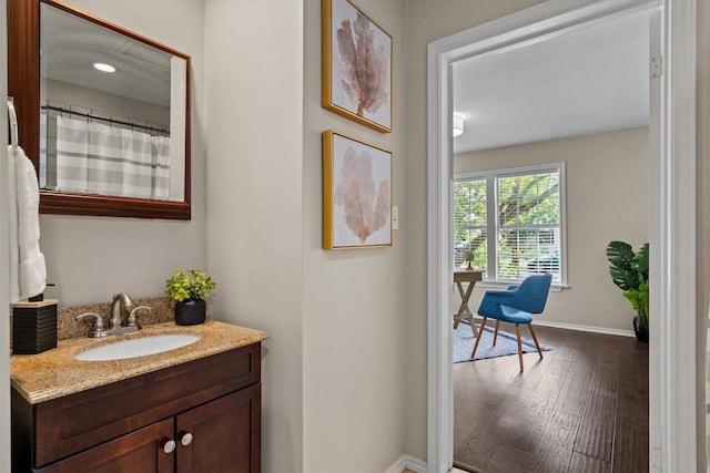 406 W 55th 1/2 St, Austin, TX 78751 - bathroom with baseboards, vanity, and wood finished floors