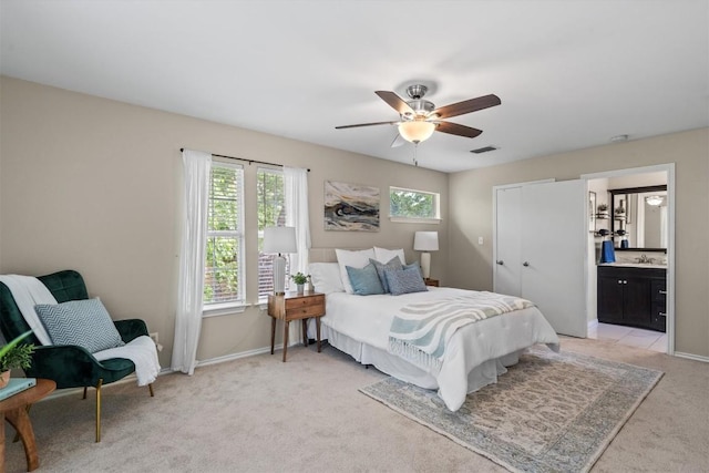 406 W 55th 1/2 St, Austin, TX 78751 - bedroom with light carpet, a sink, baseboards, and ensuite bathroom