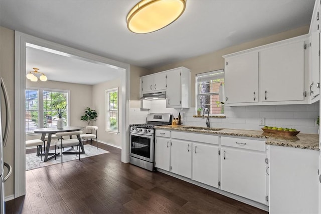 406 W 55th 1/2 St, Austin, TX 78751 - kitchen featuring gas stove, a sink, decorative backsplash, white cabinetry, and dark wood-style flooring