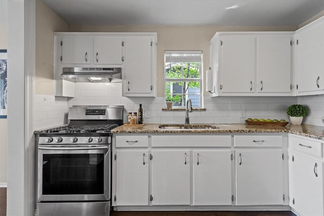 406 W 55th 1/2 St, Austin, TX 78751 - kitchen featuring exhaust hood, gas stove, a sink, white cabinetry, and decorative backsplash