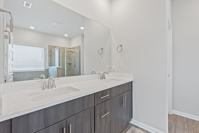 571 Sue Peaks Loop, Dripping Springs, TX 78620 - full bathroom with a sink, a stall shower, double vanity, and visible vents