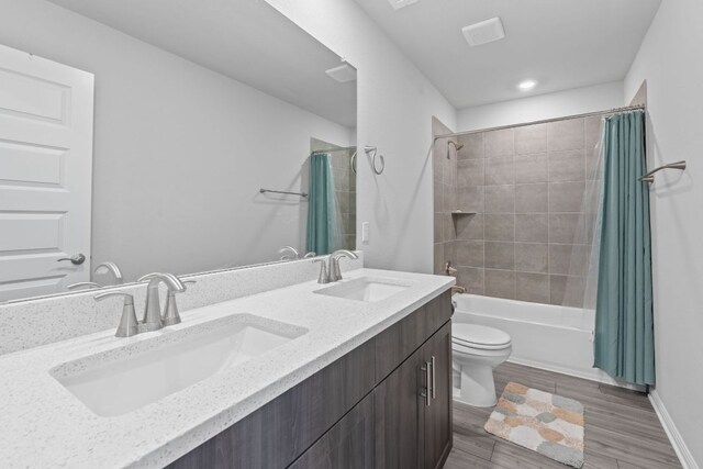 571 Sue Peaks Loop, Dripping Springs, TX 78620 - bathroom featuring double vanity, toilet, a sink, and shower / bath combo