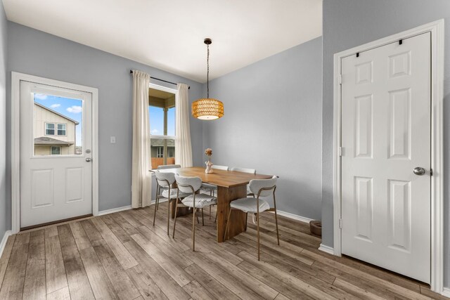 dining room with baseboards and wood finished floors
