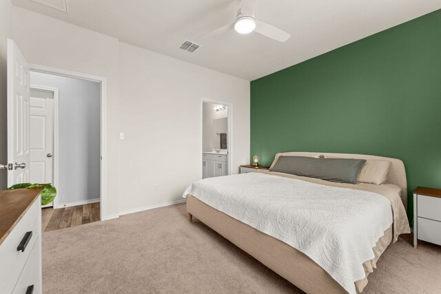 bedroom with a ceiling fan, visible vents, carpet floors, baseboards, and connected bathroom