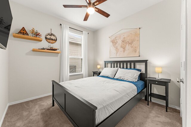 carpeted bedroom featuring baseboards and a ceiling fan