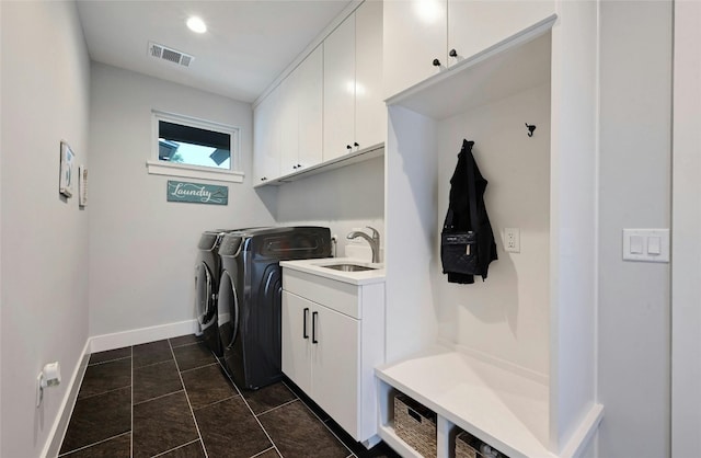laundry area with cabinet space, a sink, separate washer and dryer, baseboards, and visible vents