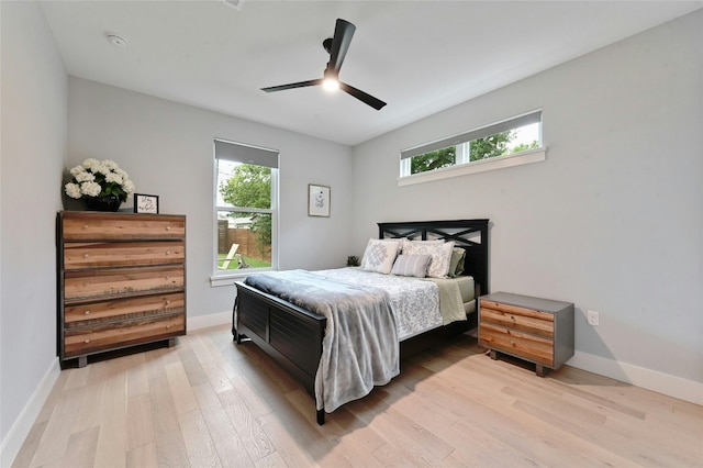 bedroom featuring multiple windows and light wood finished floors