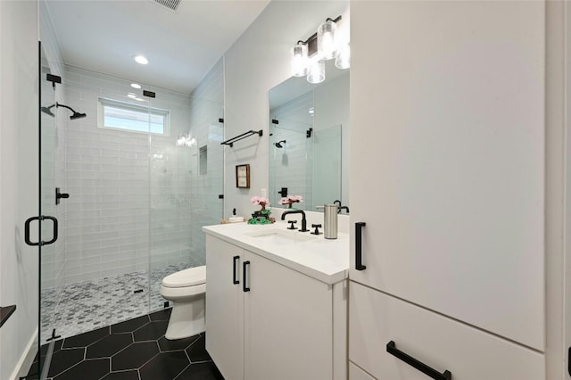 full bath featuring vanity, tile patterned floors, a shower stall, and toilet