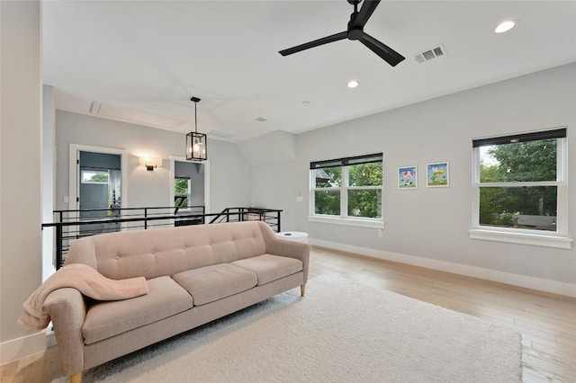 living area with ceiling fan, visible vents, wood finished floors, baseboards, and recessed lighting