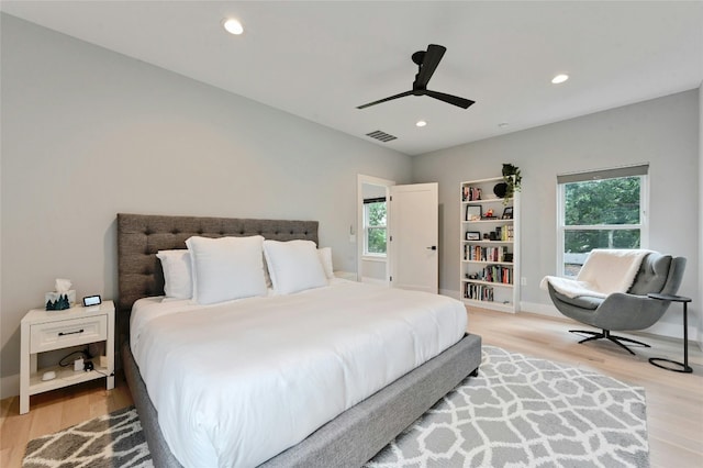 bedroom featuring light wood-style floors, recessed lighting, visible vents, and multiple windows