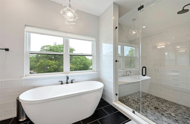 bathroom with a freestanding tub, tile walls, tile patterned floors, a stall shower, and vaulted ceiling