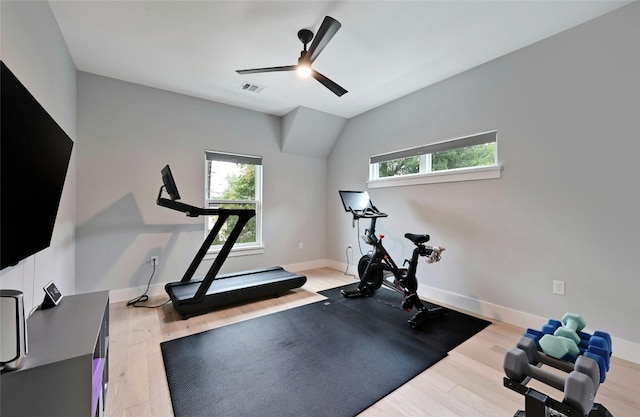 workout room with a ceiling fan, baseboards, and light wood-type flooring
