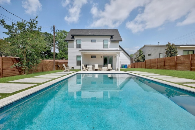 view of swimming pool featuring a patio, a fenced in pool, and a fenced backyard