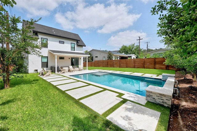view of swimming pool featuring a lawn, a fenced in pool, cooling unit, a fenced backyard, and a patio