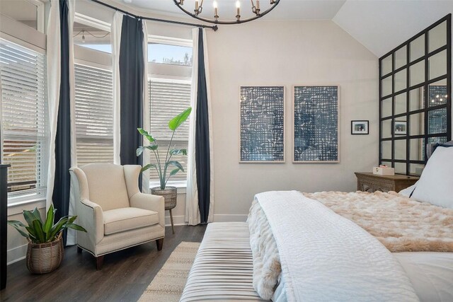 bedroom with an inviting chandelier, baseboards, wood finished floors, and vaulted ceiling
