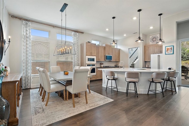 5812 Antelope Well Ln, Austin, TX 78738 - dining room with dark wood-style flooring, a chandelier, and recessed lighting