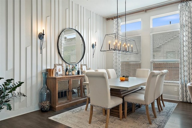5812 Antelope Well Ln, Austin, TX 78738 - dining area featuring a chandelier, wood finished floors, and baseboards