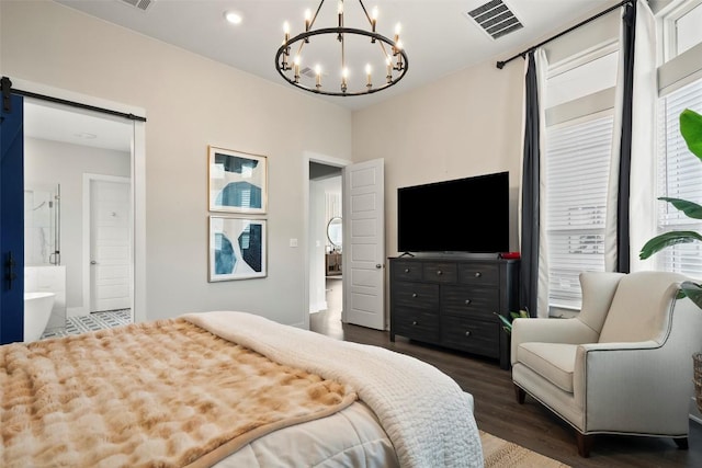 5812 Antelope Well Ln, Austin, TX 78738 - bedroom featuring a barn door, a chandelier, wood finished floors, and connected bathroom