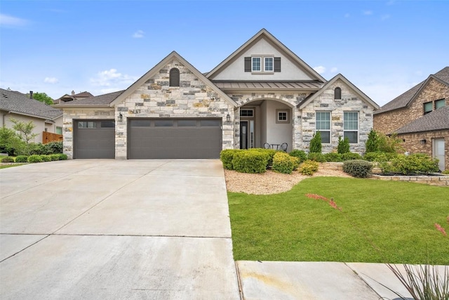 view of front of property with a garage, stucco siding, a front yard, a standing seam roof, and driveway