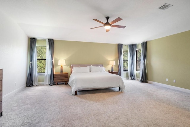bedroom featuring a ceiling fan, baseboards, visible vents, and carpet