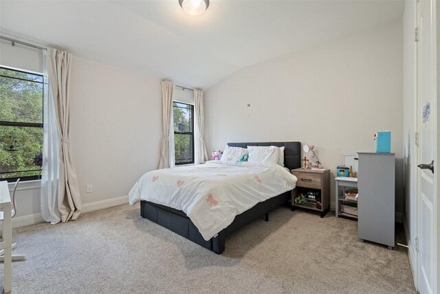 bedroom featuring carpet flooring, baseboards, vaulted ceiling, and multiple windows