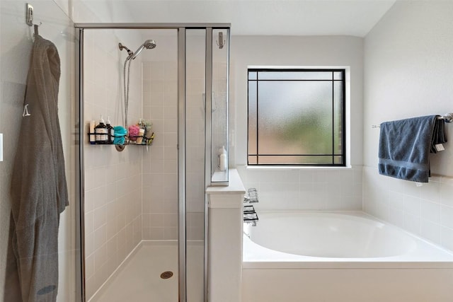 bathroom with a garden tub and a stall shower