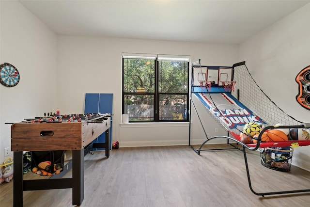 playroom featuring baseboards and wood finished floors