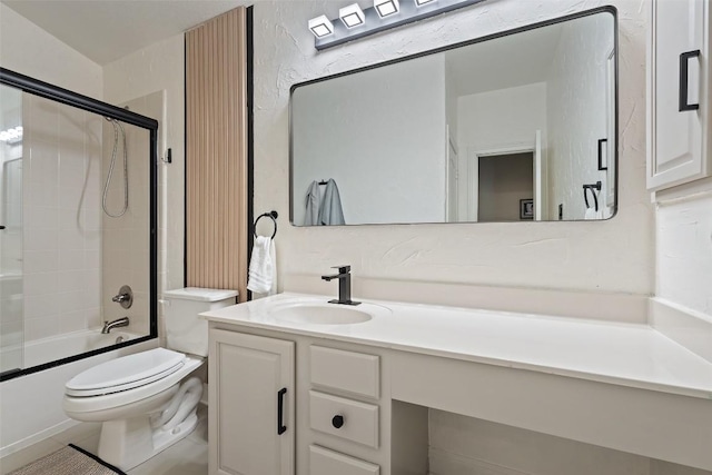 full bathroom featuring toilet, bath / shower combo with glass door, and vanity