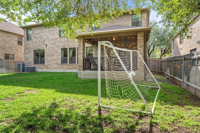 view of yard featuring central air condition unit and a fenced backyard