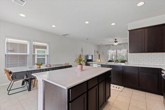 kitchen with a sink, light tile patterned floors, visible vents, and recessed lighting
